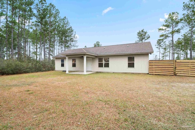 rear view of property with a patio and a yard