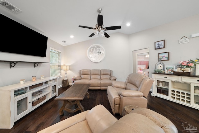 living room with dark wood-type flooring, ceiling fan, and vaulted ceiling