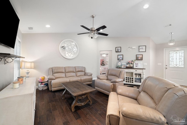 living room featuring vaulted ceiling, dark hardwood / wood-style floors, and ceiling fan