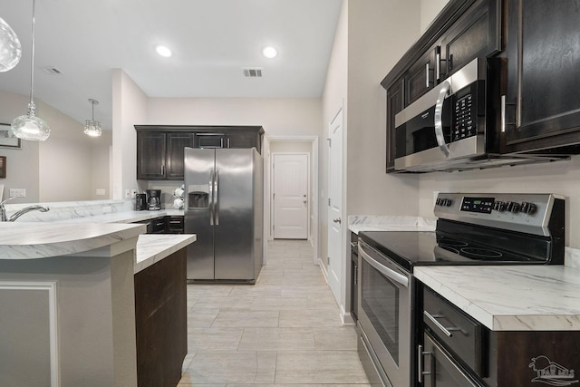 kitchen featuring sink, decorative light fixtures, and appliances with stainless steel finishes