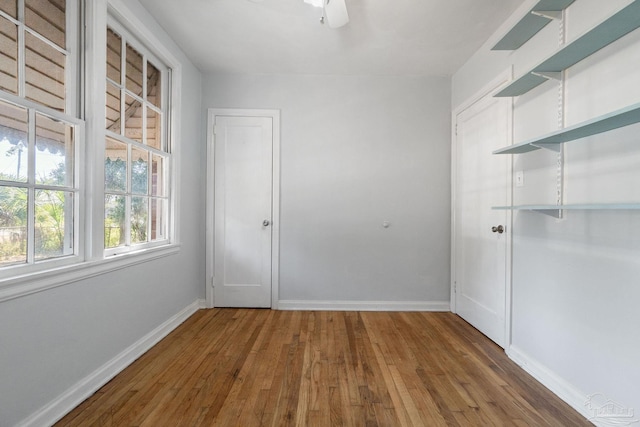 spare room featuring hardwood / wood-style flooring and ceiling fan