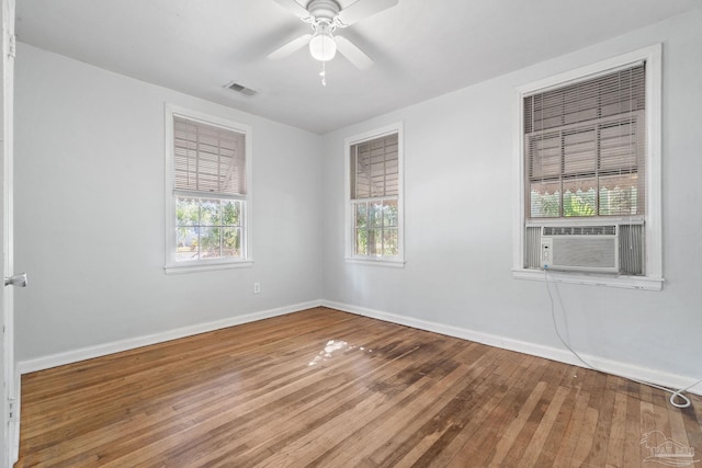 spare room with hardwood / wood-style floors, ceiling fan, and plenty of natural light