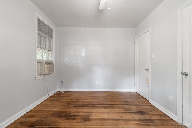 spare room with dark wood-type flooring, cooling unit, and ceiling fan