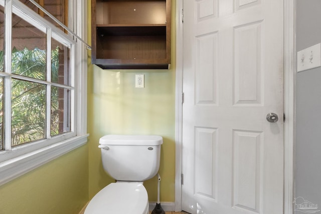 bathroom with a wealth of natural light and toilet