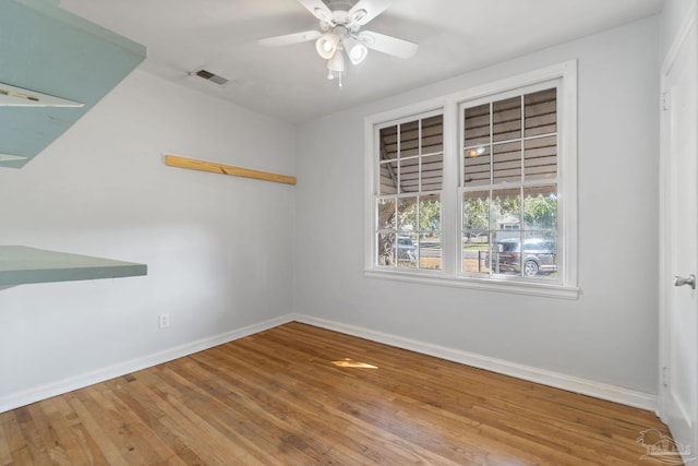 empty room featuring hardwood / wood-style floors and ceiling fan