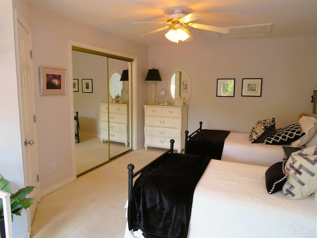 bedroom with light carpet, a closet, and ceiling fan