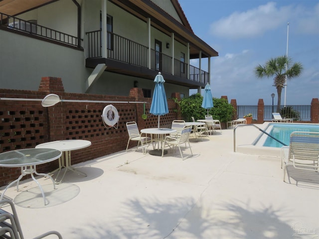 view of patio / terrace featuring a community pool