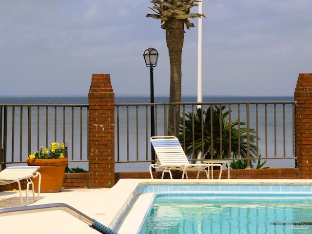 view of pool featuring a water view