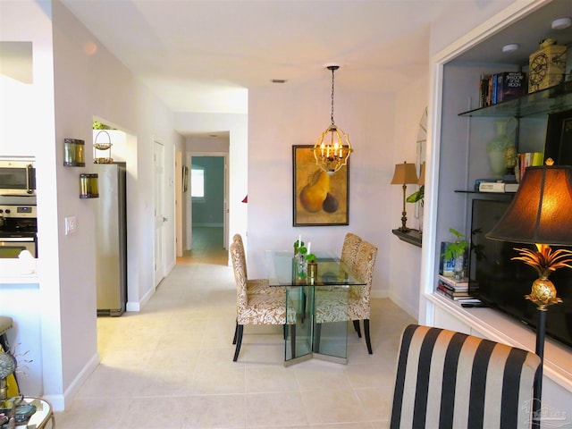 tiled dining area with a chandelier