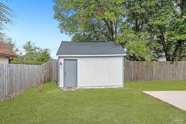 view of outbuilding with a yard