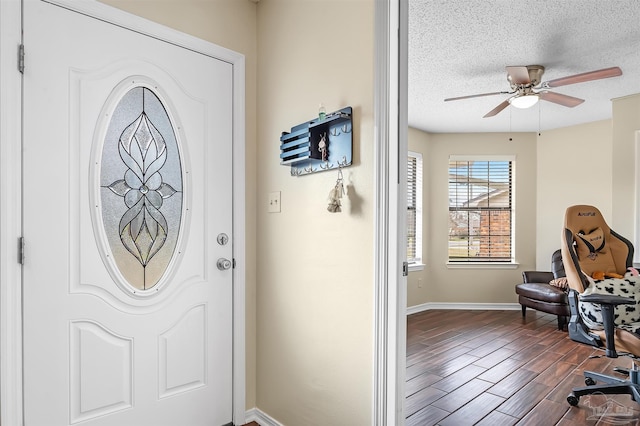 foyer entrance featuring ceiling fan and a textured ceiling