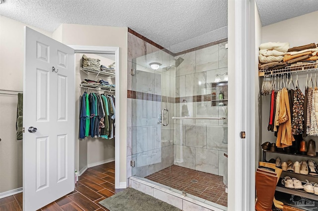 bathroom featuring a textured ceiling and walk in shower