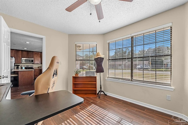 home office featuring ceiling fan and a textured ceiling