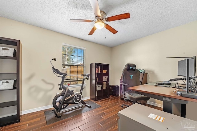 exercise room with a textured ceiling and ceiling fan