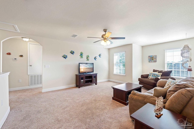 living room with light carpet, plenty of natural light, and visible vents