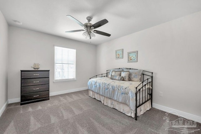 bedroom featuring a ceiling fan, light colored carpet, and baseboards