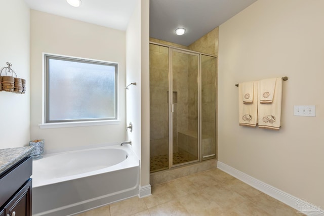 full bathroom featuring a garden tub, vanity, baseboards, a shower stall, and tile patterned floors