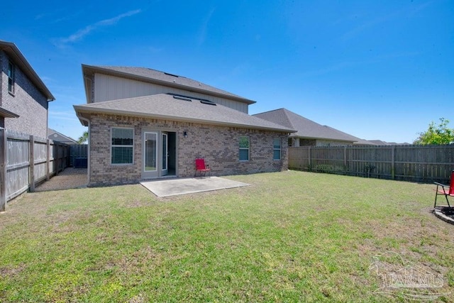 back of property featuring a patio area, brick siding, a fenced backyard, and a lawn