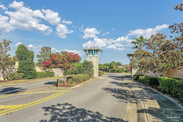 view of road with traffic signs and curbs