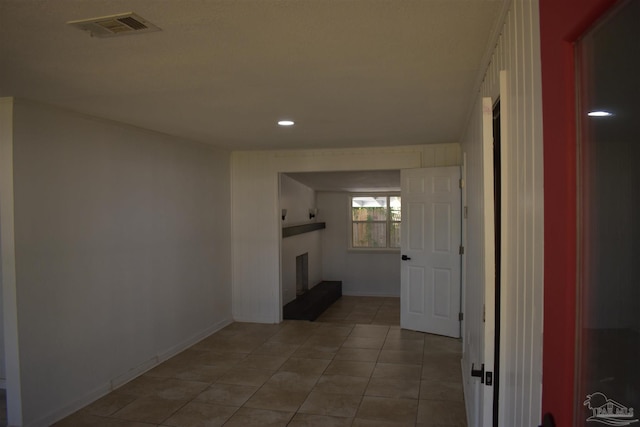 corridor with light tile patterned floors, visible vents, recessed lighting, and baseboards