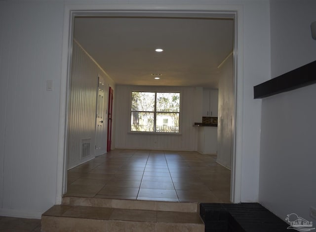 corridor featuring visible vents and light tile patterned floors