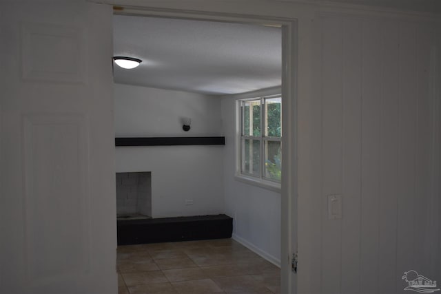 hall with wood walls and tile patterned flooring