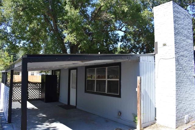 exterior space with fence and a carport