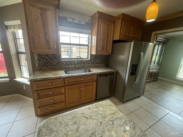 7844 Bay Meadows Dr, Pensacola, FL 32507 - kitchen featuring light tile patterned floors, tasteful backsplash, stainless steel appliances, and a sink