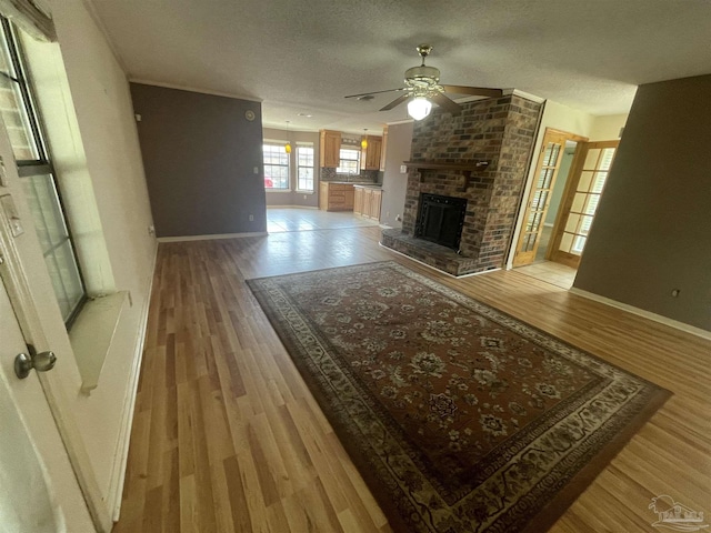 7844 Bay Meadows Dr, Pensacola, FL 32507 - unfurnished living room featuring ceiling fan, baseboards, and light wood-style floors