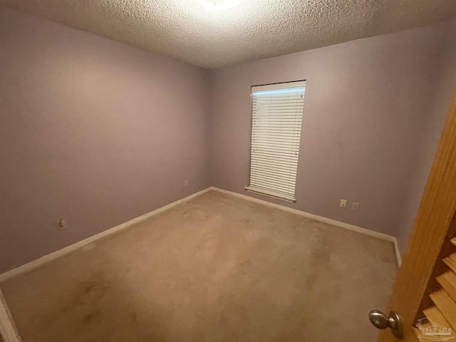 7844 Bay Meadows Dr, Pensacola, FL 32507 - carpeted empty room featuring baseboards and a textured ceiling