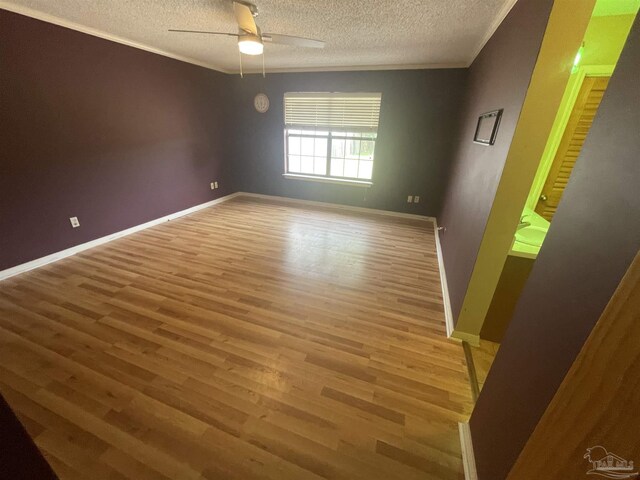 7844 Bay Meadows Dr, Pensacola, FL 32507 - spare room with a ceiling fan, crown molding, a textured ceiling, light wood-style floors, and baseboards