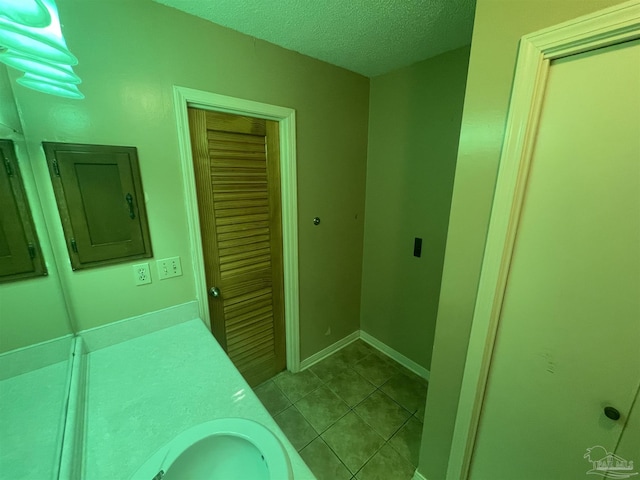 7844 Bay Meadows Dr, Pensacola, FL 32507 - bathroom featuring electric panel, a textured ceiling, tile patterned flooring, and vanity