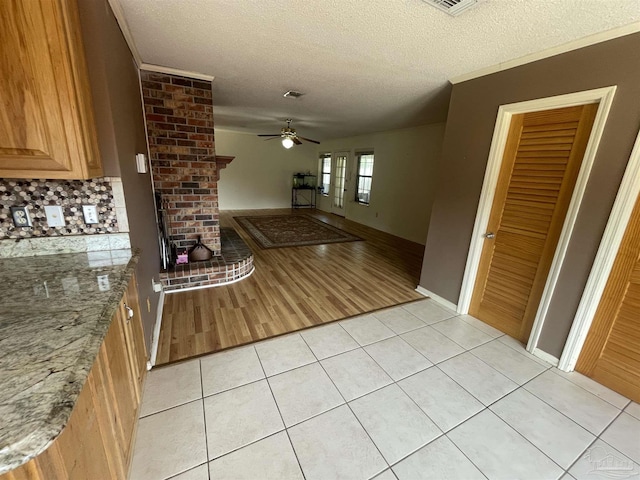 7844 Bay Meadows Dr, Pensacola, FL 32507 - interior space featuring light stone counters, a textured ceiling, ceiling fan, and light tile patterned floors
