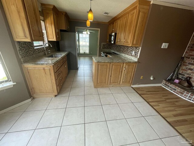 7844 Bay Meadows Dr, Pensacola, FL 32507 - kitchen with backsplash, visible vents, light tile patterned floors, a sink, and appliances with stainless steel finishes