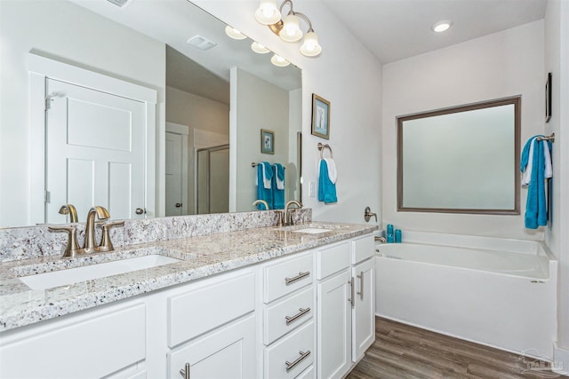 bathroom with vanity, hardwood / wood-style flooring, and independent shower and bath