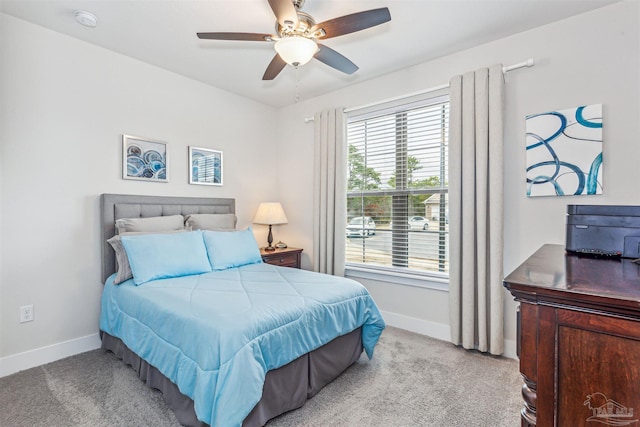 bedroom with ceiling fan and light colored carpet