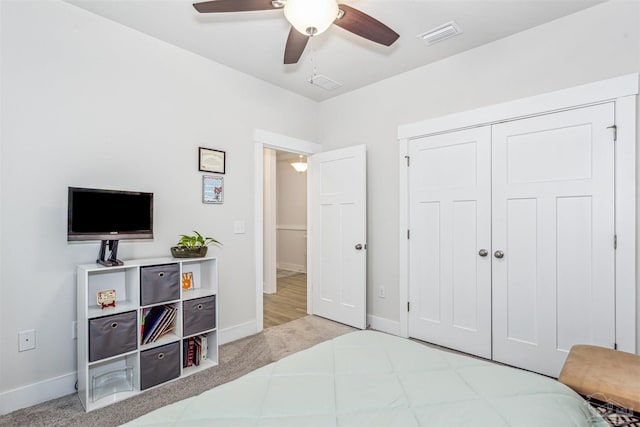 bedroom featuring ceiling fan, a closet, and light carpet