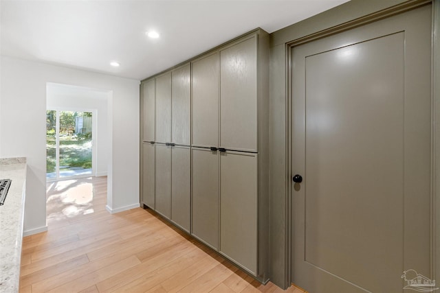 hallway with light hardwood / wood-style flooring