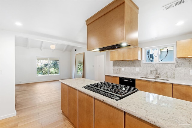 kitchen featuring gas cooktop, light stone countertops, sink, and dishwasher