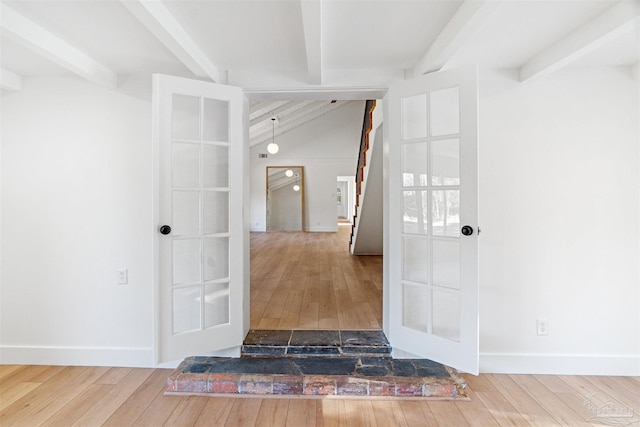 interior space featuring vaulted ceiling with beams and hardwood / wood-style floors