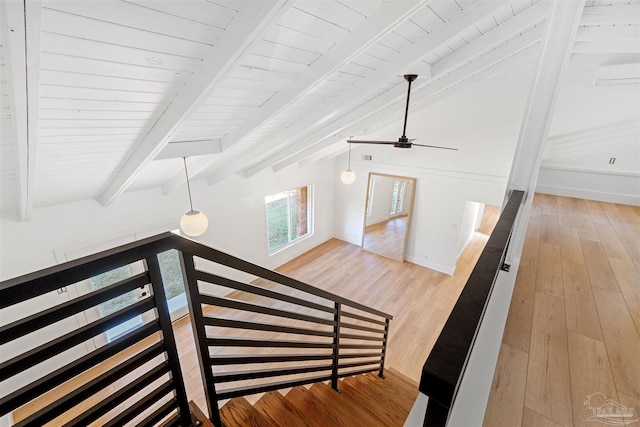 stairs featuring hardwood / wood-style flooring, vaulted ceiling with beams, a wall mounted air conditioner, and wood ceiling