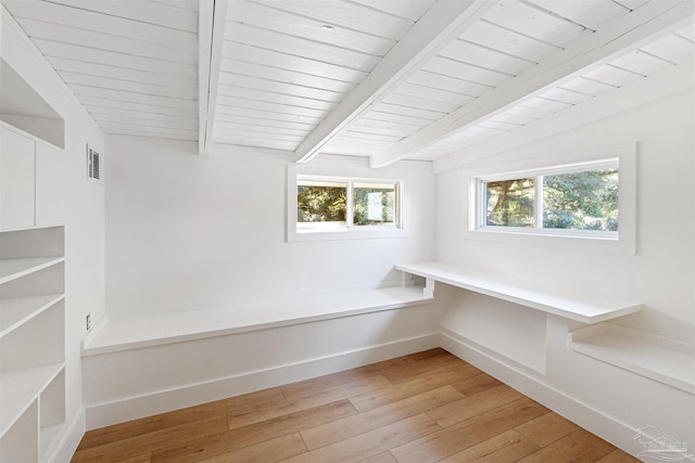 interior space featuring light hardwood / wood-style flooring and lofted ceiling with beams