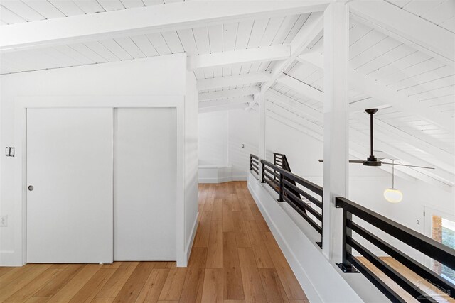 hall featuring wood-type flooring, lofted ceiling with beams, and wooden ceiling