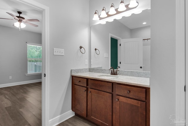 bathroom featuring baseboards, a ceiling fan, vanity, and wood finished floors