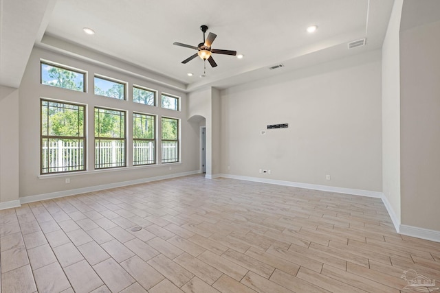 12789 Island Spirit Dr, Pensacola, FL 32506 - spare room with arched walkways, a raised ceiling, visible vents, and ceiling fan