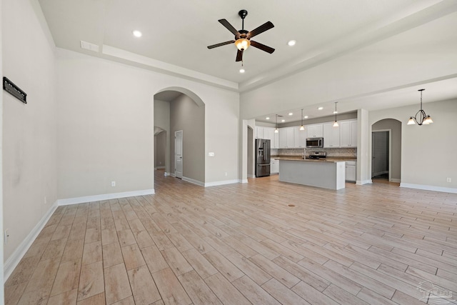 12789 Island Spirit Dr, Pensacola, FL 32506 - unfurnished living room with arched walkways, baseboards, visible vents, recessed lighting, and a ceiling fan