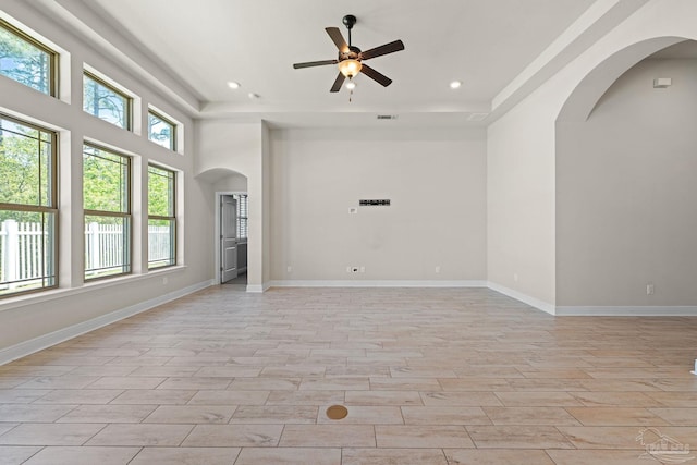 12789 Island Spirit Dr, Pensacola, FL 32506 - unfurnished room featuring arched walkways, recessed lighting, ceiling fan, wood tiled floor, and a raised ceiling