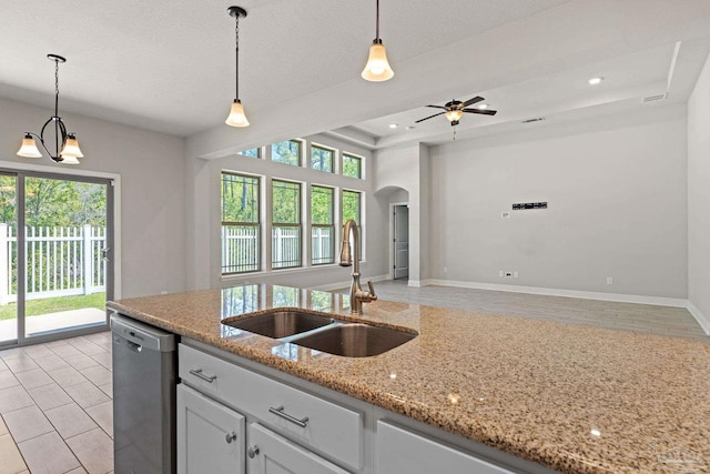 12789 Island Spirit Dr, Pensacola, FL 32506 - kitchen featuring stainless steel dishwasher, arched walkways, a sink, open floor plan, and hanging light fixtures
