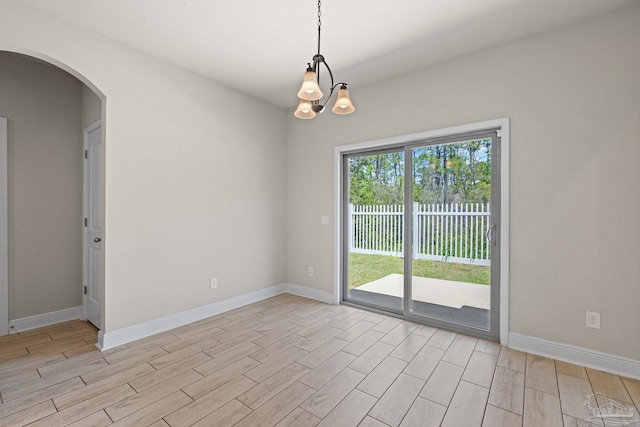 12789 Island Spirit Dr, Pensacola, FL 32506 - unfurnished room with arched walkways, wood finish floors, and baseboards