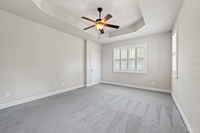 12789 Island Spirit Dr, Pensacola, FL 32506 - carpeted spare room with a raised ceiling, baseboards, and ceiling fan